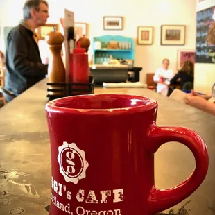 Sitting at the back counter with an excellent cup of GiGi's coffee.