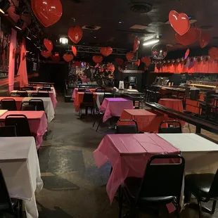 tables and chairs with pink tablecloths