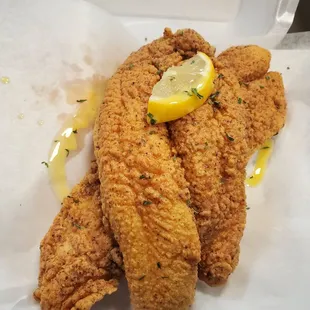 fried chicken with a lemon wedge