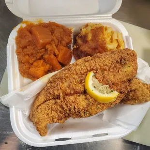 a tray of fried fish and mashed potatoes