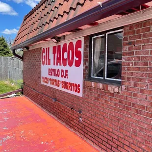 a brick building with a sign for a business