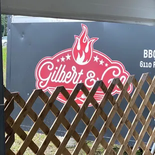 a bbq sign and a fence