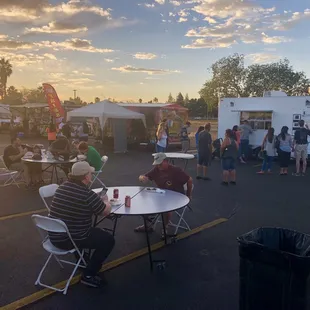 Seating area surrounded by food trucks, in mid April 2019.