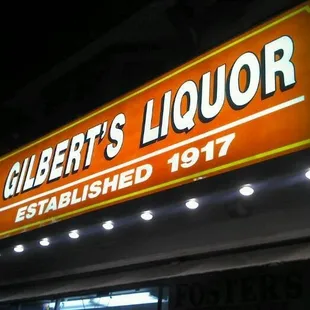 a neon sign for gilbert's liquor