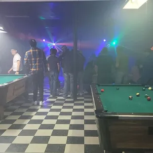 a pool table and a crowd of people