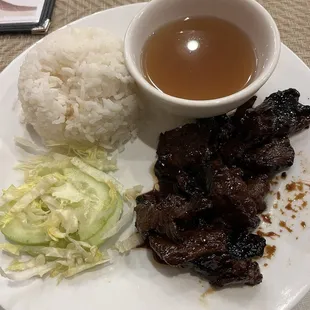 Grilled pork rice dish with lettuce, cucumber and a side of the chicken pho broth.