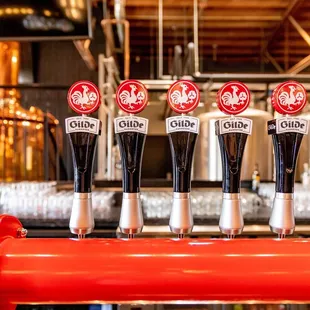 a row of beer taps