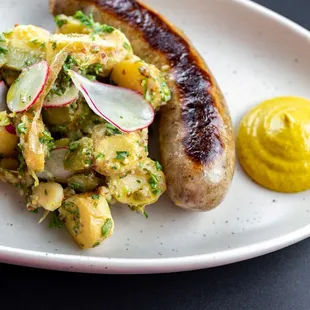 Bavarian Bratwurst: Seared German sausage served with a French roll, smooth mustard, and a choice of sauerkraut or potato salad.