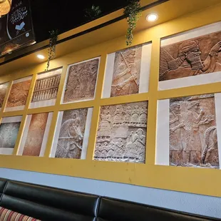 a wall full of paintings
