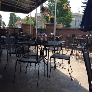 a patio with tables and chairs