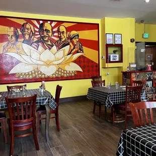 a restaurant with a large mural on the wall
