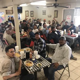 a large group of people sitting at a table