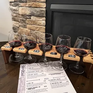 a flight of wine glasses on a table