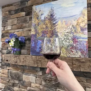 a hand holding a glass of wine