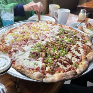 a woman cutting a pizza