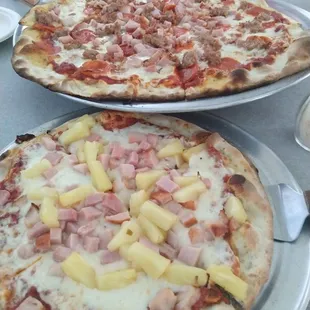 two pizzas with pineapple toppings