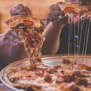 a man eating a slice of pizza