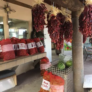 a variety of chilis hanging from the ceiling