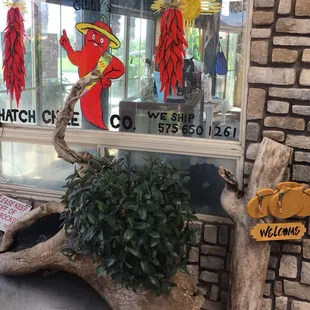 a window with a sign and a plant