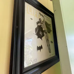 a batman poster in a frame