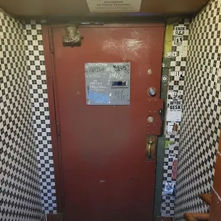 a red door with checkered walls