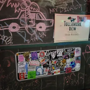 a chalkboard with stickers on it