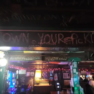 a sign that says own your drink