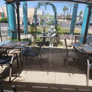 a patio with tables and chairs