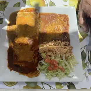 Beef burrito with a small salad beans and rice.