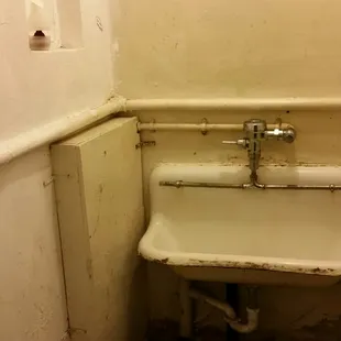 a sink in the corner of a room