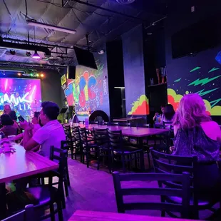 people sitting at tables in a brightly lit restaurant