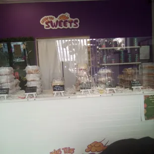 Front counter of cakes and pies  and pay on the side.