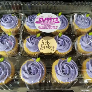 Lemon cupcakes with lavender color frosting.