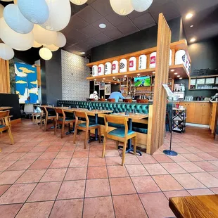 Seating in front of the bar. There are 7 seats at the bar. The front door is to the far right.