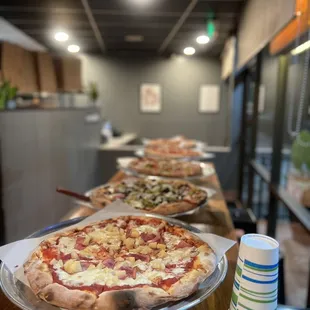 a row of pizzas