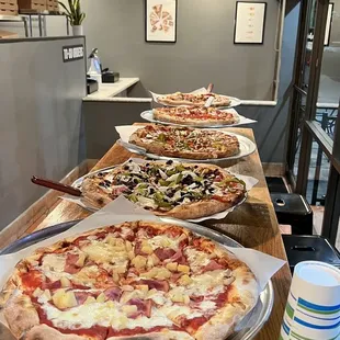 a row of pizzas