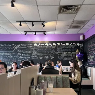 people sitting at tables in a restaurant