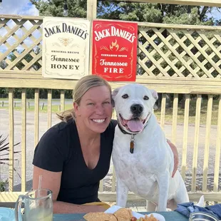 a smiling woman and her dog