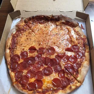 Half cheese, half pepperoni, burn on the top.