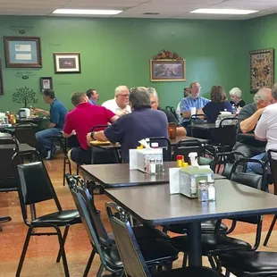 a large group of people sitting at tables
