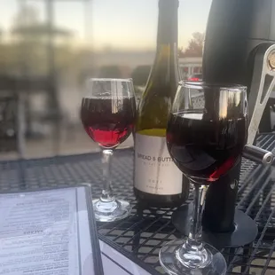two glasses of wine and a menu