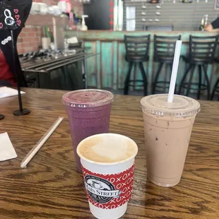 An iced chai tea latte, a vanilla hot coffee, and a blu-nana smoothie