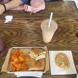 Turkey avocado panini, chips, a white macadamia cookie, and an iced chai tea latte