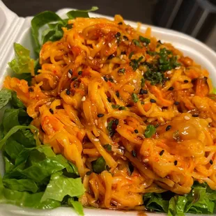 a close up of a salad in a styrofoam container