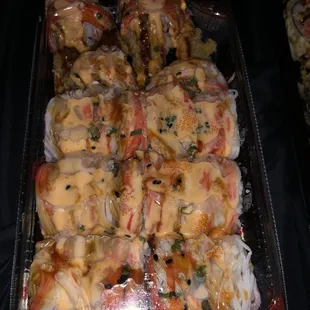 a tray of chicken wrapped in cheese