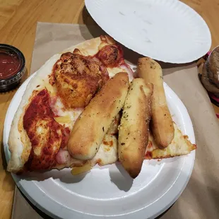 a slice of pepperoni pizza on a paper plate
