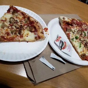 two slices of pizza on paper plates
