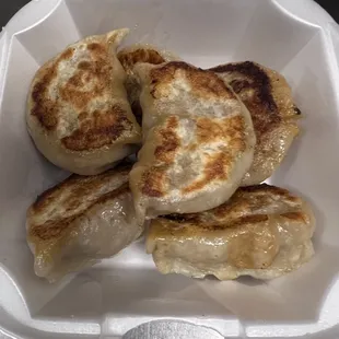 Gently steamed pork dumplings then fried crispy over a grill.