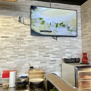 Sitting at the sushi bar watching a large screen TV that worked well