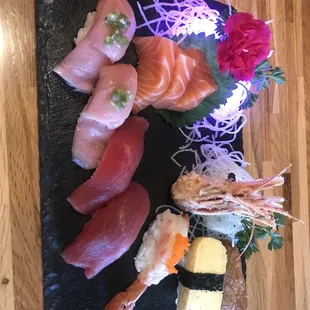 Salmon sashimi, tamago (egg cake), amaebi (sweet shrimp), inari (tofu skin), toro, and blue fin tuna